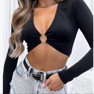 Long sleeved cropped top with gold ring in the middle